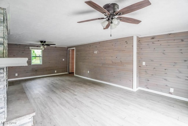 29655 Buck Rd, Salem, OH 44460 - unfurnished living room featuring ceiling fan, wood finished floors, wooden walls, and baseboards