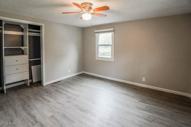 29655 Buck Rd, Salem, OH 44460 - unfurnished bedroom featuring wood finished floors, baseboards, ceiling fan, and a closet