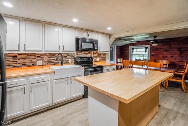 29655 Buck Rd, Salem, OH 44460 - kitchen with butcher block counters, black appliances, a sink, light wood-style flooring, and recessed lighting