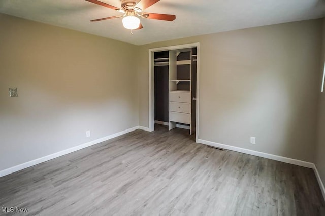 29655 Buck Rd, Salem, OH 44460 - unfurnished bedroom featuring baseboards, wood finished floors, a closet, and a ceiling fan