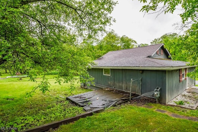 29655 Buck Rd, Salem, OH 44460 - view of side of home with board and batten siding, a yard, and roof with shingles