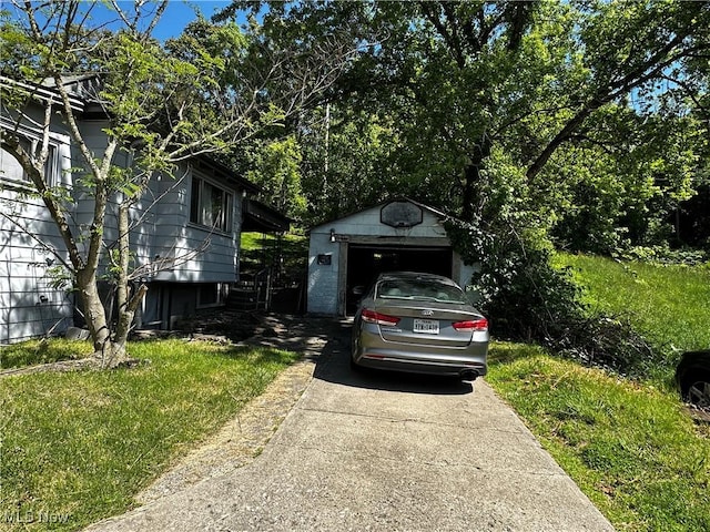 1836 Colerain Pike, Martins Ferry, OH 43935 - view of front of home featuring a garage, an outbuilding, and concrete driveway