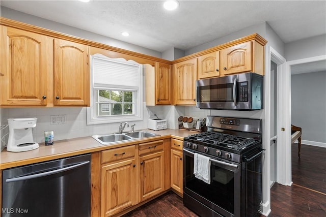 360 Woodside Ave NE, North Canton, OH 44720 - kitchen with stainless steel appliances, a sink, recessed lighting, decorative backsplash, and dark wood-style flooring