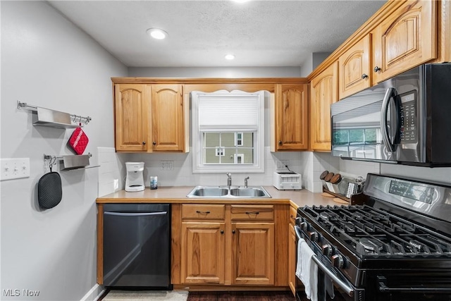 360 Woodside Ave NE, North Canton, OH 44720 - kitchen featuring range with gas cooktop, dishwasher, a sink, light countertops, and recessed lighting