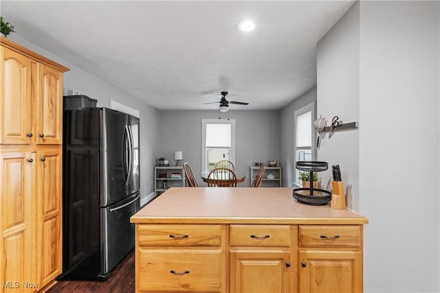 360 Woodside Ave NE, North Canton, OH 44720 - kitchen with freestanding refrigerator, dark wood finished floors, a ceiling fan, light countertops, and a peninsula