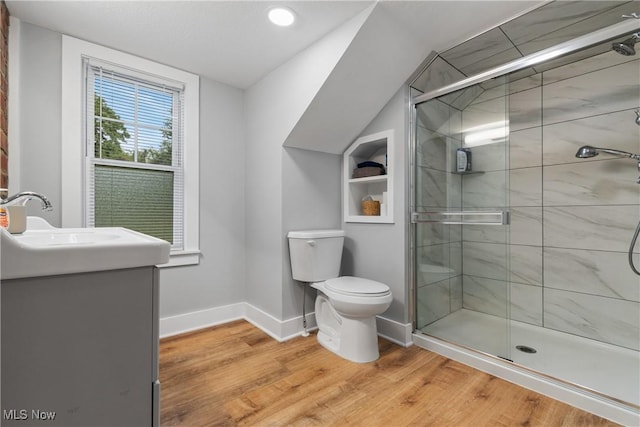 360 Woodside Ave NE, North Canton, OH 44720 - bathroom with wood finished floors, toilet, a stall shower, vanity, and vaulted ceiling