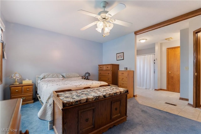 3645 Glen Eagles Blvd, Green, OH 44685 - bedroom with light carpet, light tile patterned flooring, ceiling fan, and baseboards