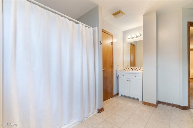 3645 Glen Eagles Blvd, Green, OH 44685 - bathroom with vanity, baseboards, and curtained shower