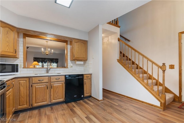 3645 Glen Eagles Blvd, Green, OH 44685 - kitchen featuring dishwasher, a sink, backsplash, wood finished floors, and light countertops