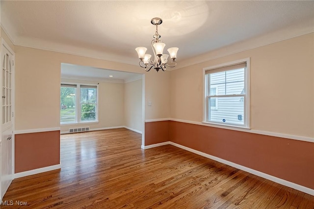4092 Charlton Rd, South Euclid, OH 44121 - spare room featuring wood finished floors, a chandelier, crown molding, and baseboards