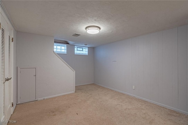 4092 Charlton Rd, South Euclid, OH 44121 - below grade area featuring light carpet, a textured ceiling, and baseboards