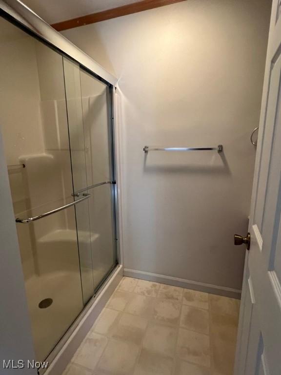 139 E Walnut St, Barnesville, OH 43713 - bathroom featuring a stall shower and baseboards