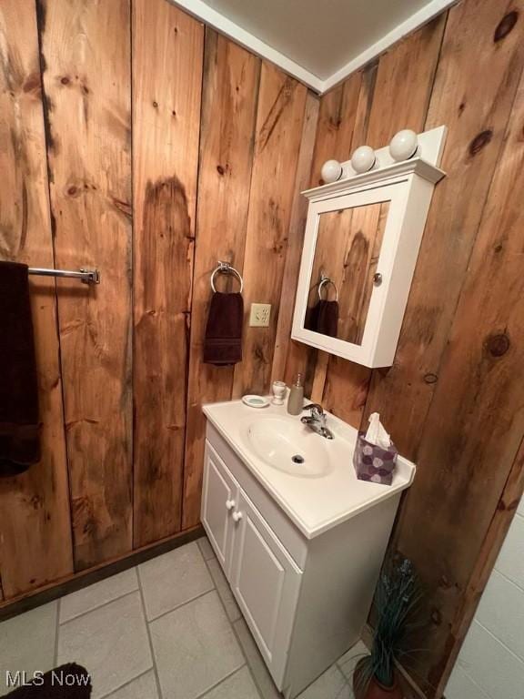 139 E Walnut St, Barnesville, OH 43713 - bathroom featuring vanity, wood walls, and tile patterned floors