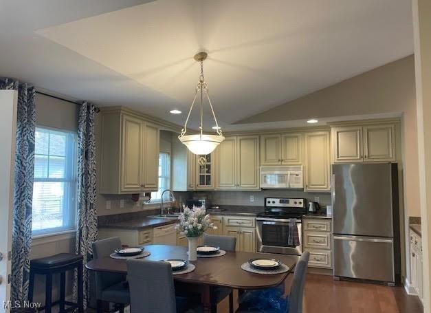 170 Sandy Ct Unit 11, New Middletown, OH 44442 - kitchen featuring appliances with stainless steel finishes, cream cabinets, a sink, dark countertops, and recessed lighting