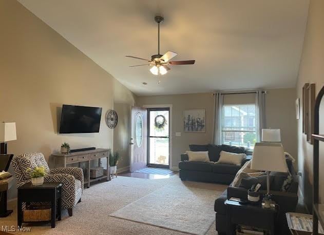 170 Sandy Ct Unit 11, New Middletown, OH 44442 - living area featuring vaulted ceiling, healthy amount of natural light, a ceiling fan, carpet flooring, and baseboards