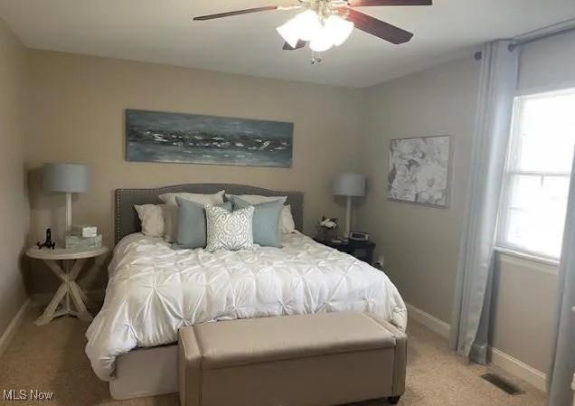 170 Sandy Ct Unit 11, New Middletown, OH 44442 - bedroom with light colored carpet, baseboards, and a ceiling fan