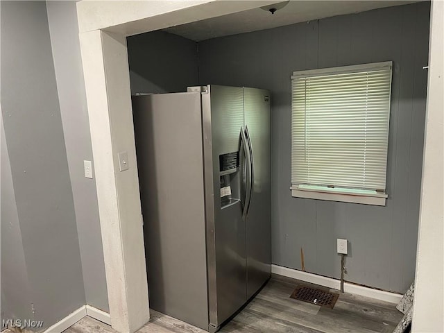 14413 Coit Rd, Cleveland, OH 44110 - kitchen featuring stainless steel refrigerator with ice dispenser, wood finished floors, and baseboards