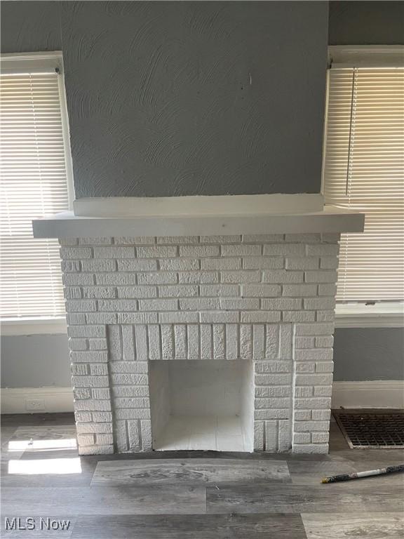 14413 Coit Rd, Cleveland, OH 44110 - detailed view of a fireplace, wood finished floors, and baseboards