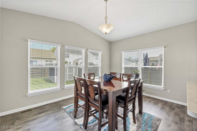 4527 Cupola Dr, Lorain, OH 44053 - dining area featuring plenty of natural light, vaulted ceiling, dark wood-style floors, and baseboards