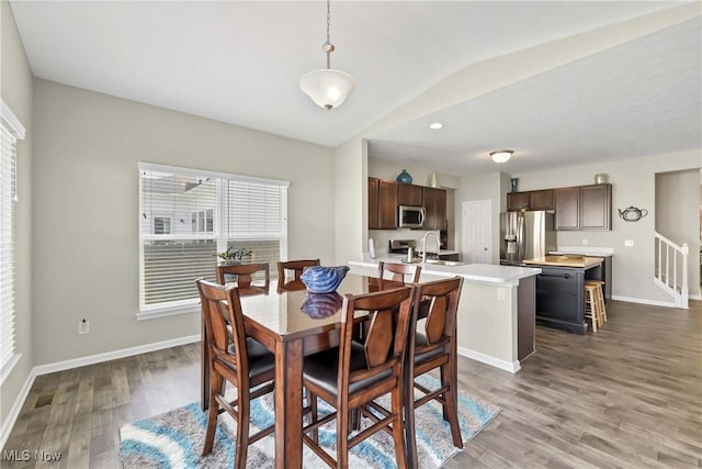 4527 Cupola Dr, Lorain, OH 44053 - dining room with wood finished floors, baseboards, and lofted ceiling