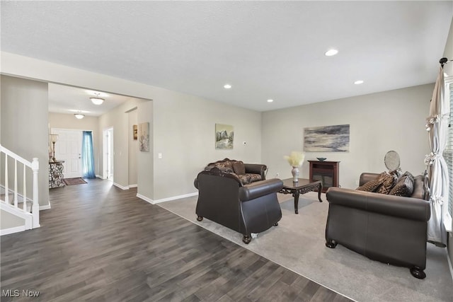 4527 Cupola Dr, Lorain, OH 44053 - living room featuring wood finished floors, stairway, baseboards, and recessed lighting