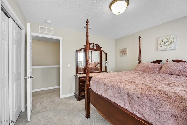 4527 Cupola Dr, Lorain, OH 44053 - bedroom featuring light colored carpet, a closet, baseboards, and a textured ceiling