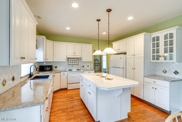 835 Thelma Dr, Wadsworth, OH 44281 - kitchen featuring white appliances, a sink, backsplash, white cabinetry, and recessed lighting