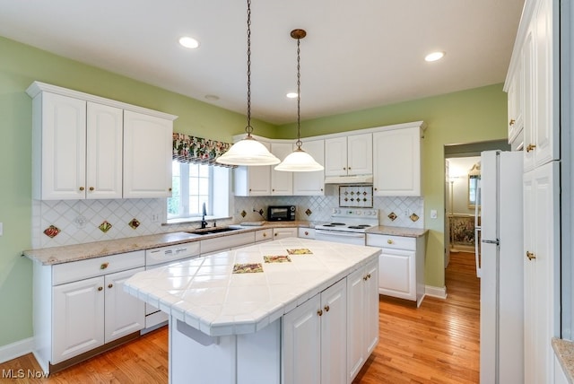 835 Thelma Dr, Wadsworth, OH 44281 - kitchen with white appliances, a sink, white cabinetry, light wood finished floors, and recessed lighting