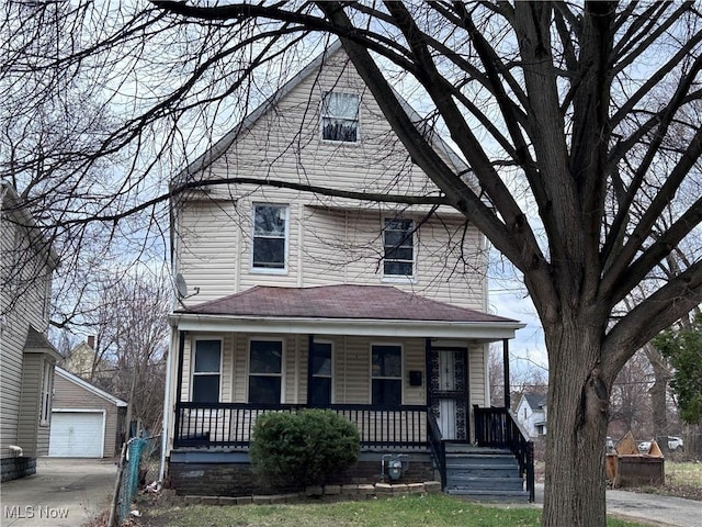 927 E 146th St, Cleveland, OH 44110 - traditional style home with a porch, an outbuilding, concrete driveway, and a detached garage