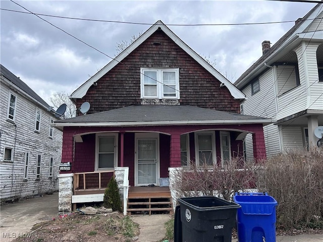 10209 Elwell Ave, Cleveland, OH 44104 - view of front facade featuring a porch and roof with shingles