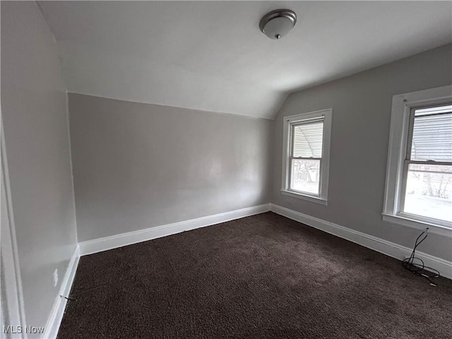 2920 E 111th St, Cleveland, OH 44104 - additional living space with vaulted ceiling, dark colored carpet, plenty of natural light, and baseboards