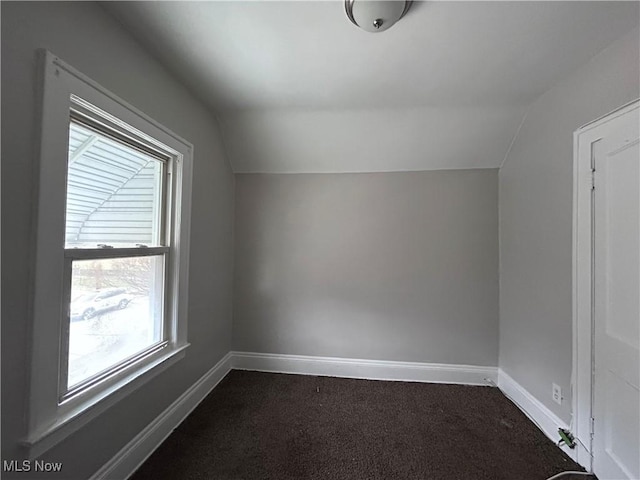 2920 E 111th St, Cleveland, OH 44104 - bonus room with vaulted ceiling, dark carpet, and baseboards