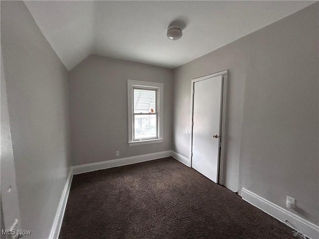 2920 E 111th St, Cleveland, OH 44104 - additional living space featuring dark carpet, vaulted ceiling, and baseboards