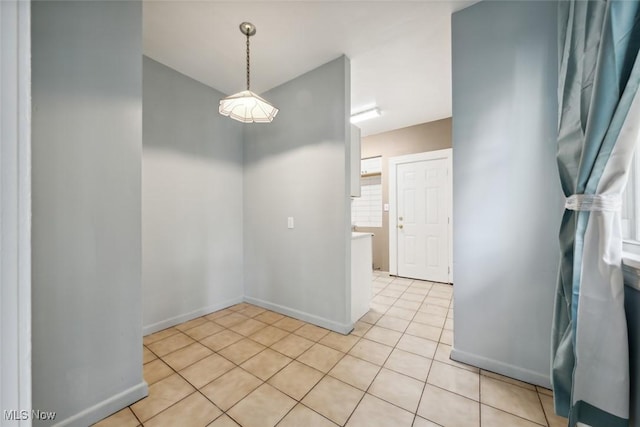 3399 E 65th St, Cleveland, OH 44127 - unfurnished dining area featuring baseboards and light tile patterned floors