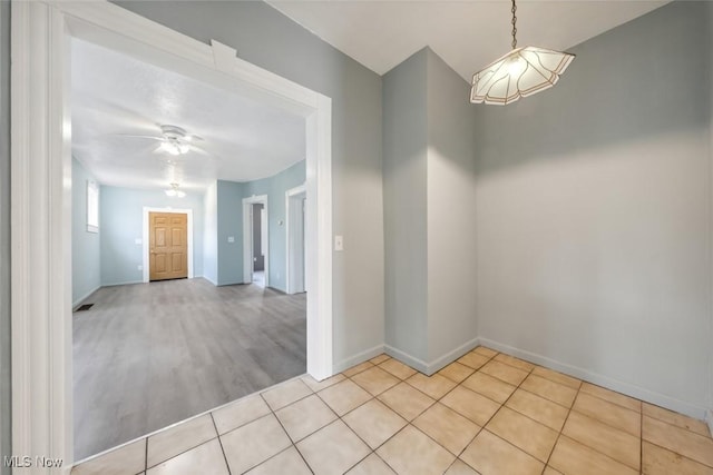 3399 E 65th St, Cleveland, OH 44127 - empty room featuring baseboards, a ceiling fan, and light tile patterned floors