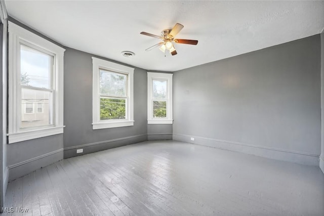 3399 E 65th St, Cleveland, OH 44127 - empty room featuring ceiling fan, wood-type flooring, and baseboards
