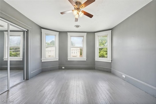 3399 E 65th St, Cleveland, OH 44127 - spare room with baseboards, hardwood / wood-style floors, and plenty of natural light