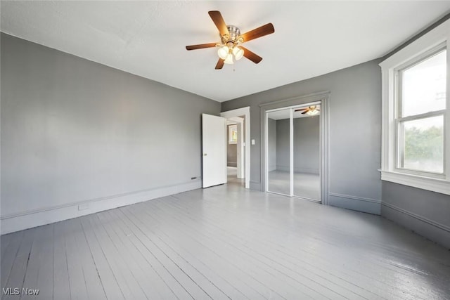 3399 E 65th St, Cleveland, OH 44127 - spare room featuring wood-type flooring, ceiling fan, and baseboards
