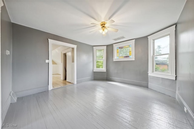 3399 E 65th St, Cleveland, OH 44127 - spare room featuring hardwood / wood-style floors, a ceiling fan, and baseboards