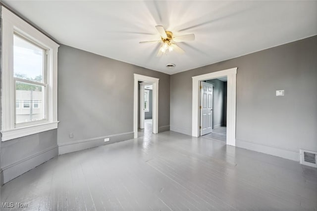 3399 E 65th St, Cleveland, OH 44127 - empty room featuring a ceiling fan, wood finished floors, and baseboards