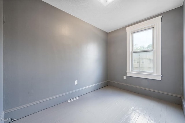 3399 E 65th St, Cleveland, OH 44127 - empty room featuring baseboards and a textured ceiling