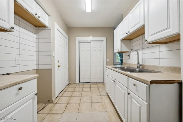 3399 E 65th St, Cleveland, OH 44127 - kitchen featuring a sink, white cabinetry, and backsplash