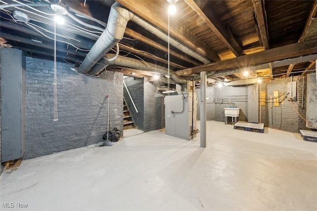 3399 E 65th St, Cleveland, OH 44127 - unfinished basement featuring stairs, a sink, and heating unit