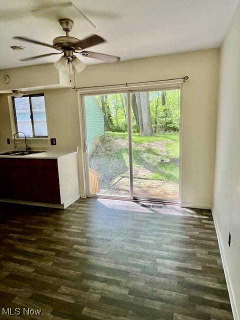 201 Valleyview Dr, Kent, OH 44240 - unfurnished living room featuring a sink, dark wood-style flooring, baseboards, and ceiling fan