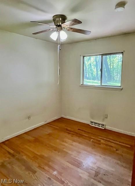 201 Valleyview Dr, Kent, OH 44240 - empty room with wood finished floors, baseboards, ceiling fan, and a smoke detector