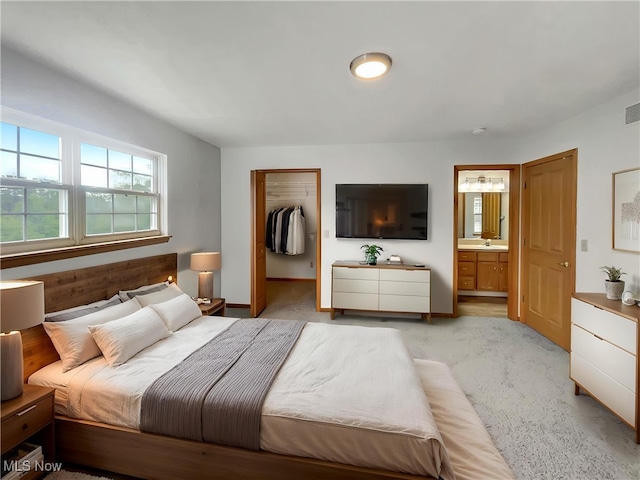 23135 Grist Mill Ct Unit 29C, Olmsted Falls, OH 44138 - bedroom featuring light carpet, a walk in closet, ensuite bath, and a closet