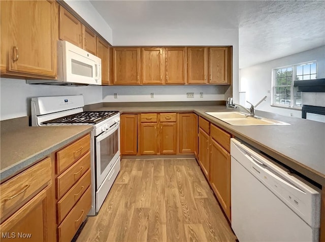 23135 Grist Mill Ct Unit 29C, Olmsted Falls, OH 44138 - kitchen featuring white appliances, a sink, light wood-type flooring, and brown cabinetry