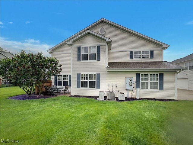 23135 Grist Mill Ct Unit 29C, Olmsted Falls, OH 44138 - rear view of property featuring a yard and a shingled roof