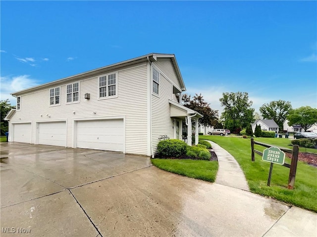 23135 Grist Mill Ct Unit 29C, Olmsted Falls, OH 44138 - view of side of home featuring concrete driveway, a garage, and a lawn