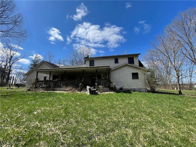 9439 Williams Rd, Diamond, OH 44412 - rear view of house with a lawn, a chimney, and covered porch